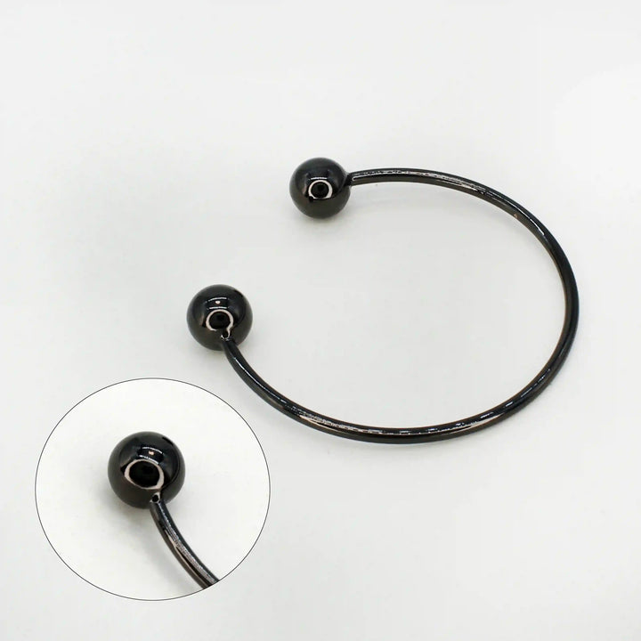 Ani Accessories Timeless Round Black Metal Buckle zooming image on the tip of  the buckle to show the buckle in the white background.