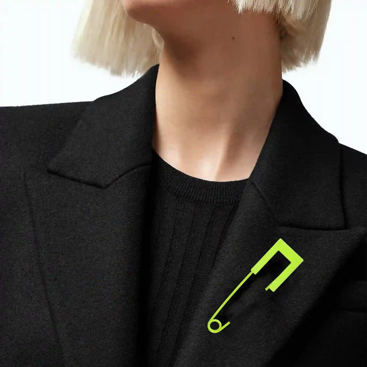 Ani Accessories safety pin worn on female model’s black jacket, perfect for styling as lapel or fashion accessory