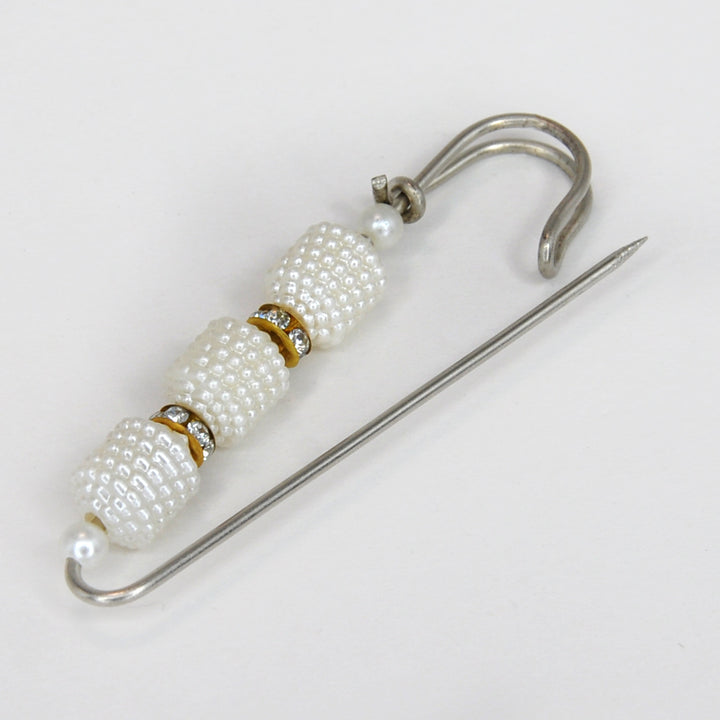 Ani Accessories Pearl brooch with gold accents on a white background