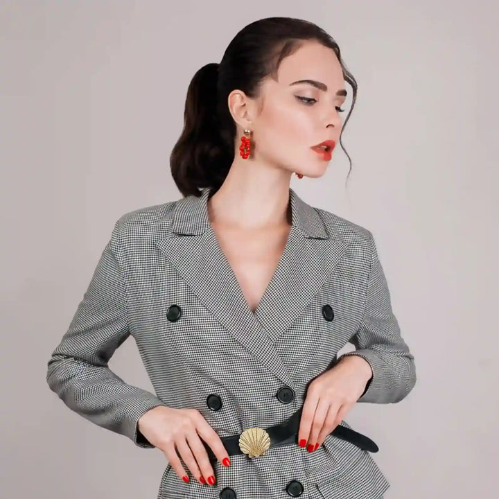 Ani Accessories Scallop Shell Metal Buckle on the black waist belt on the model blazer in the white background.
