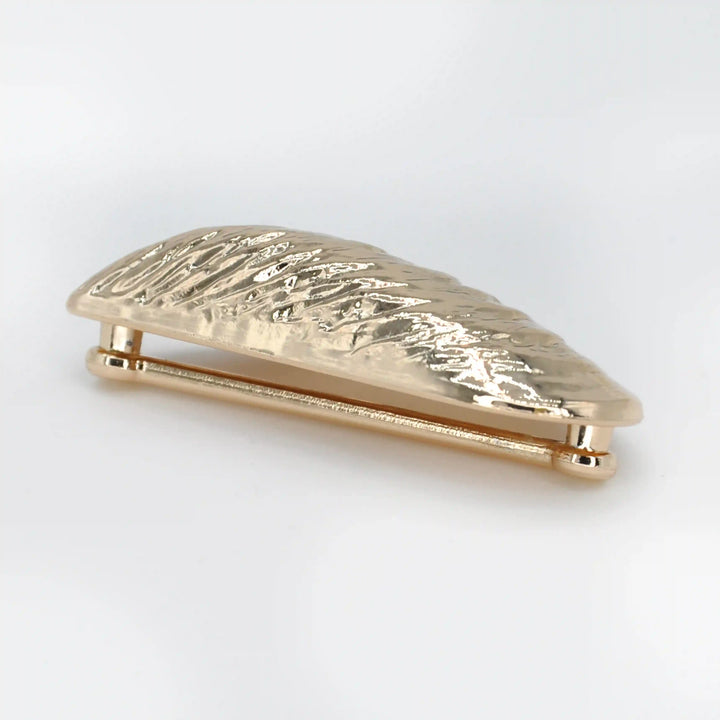 Ani Accessories Shell-Shaped Ornamental Buckle in a side view to show the thickness of the buckle in the white background.