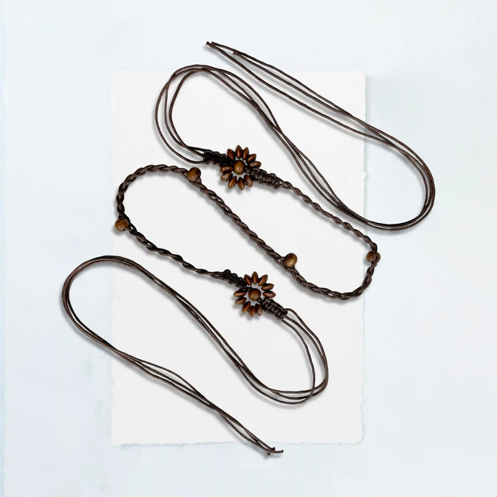 Ani Accessories Three braided hair ties with floral ends on a white background