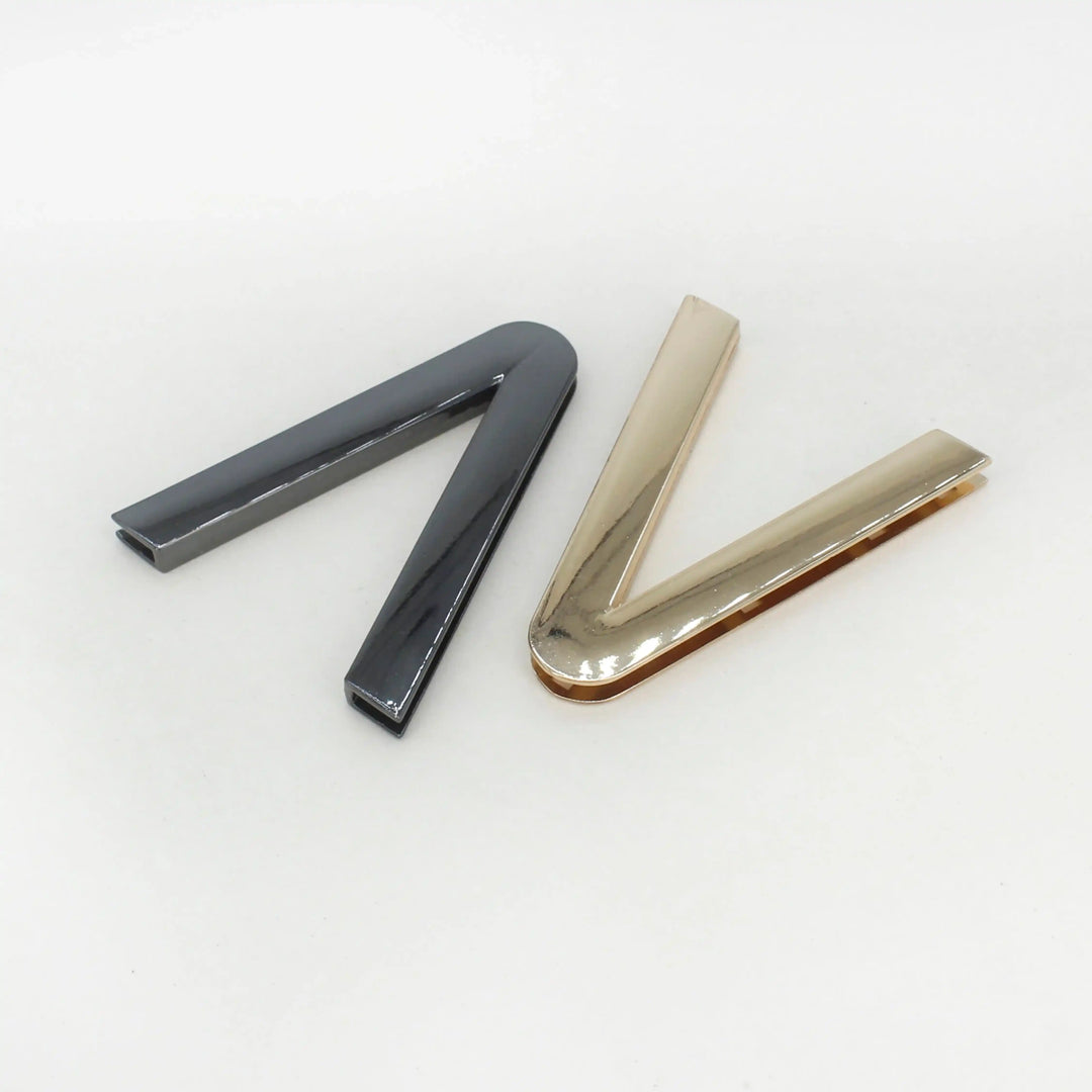  Ani Accessories V-Shaped Elegant Metal Black& gold Buckle placing in the white floor background.