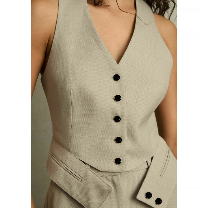 ANI Accessories black gold rim metal buttons on a beige tailored V-neck waistcoat, five down the front and two on the waist tab.