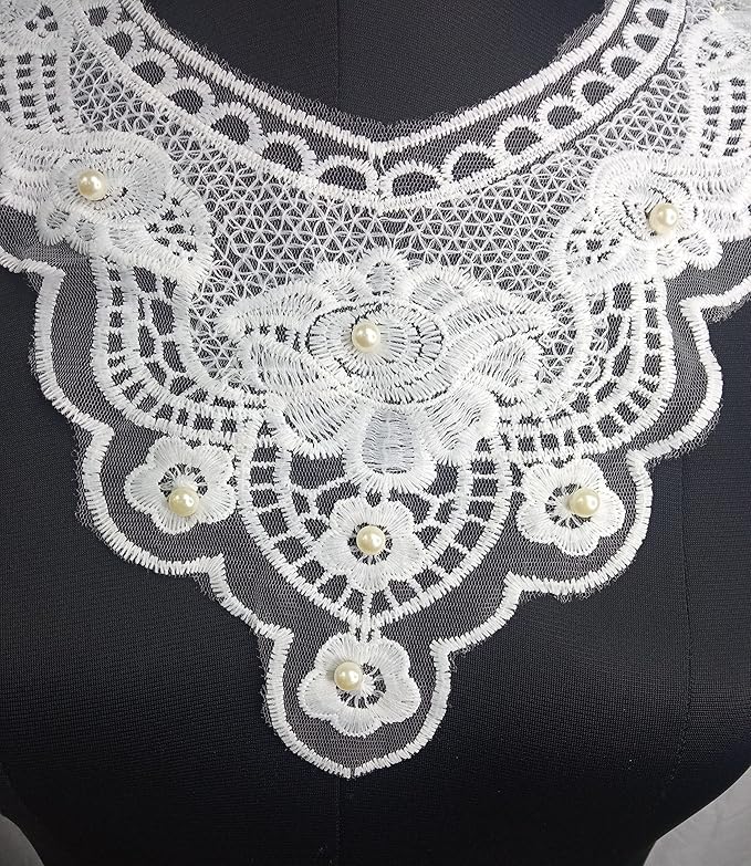 Close-up of round neckline showing intricate embroidery, fine stitching, and fabric texture for women’s kurti, dress, or blouse.