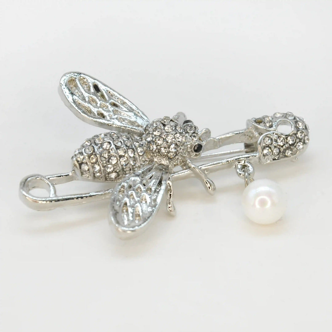 Ani Accessories close photo of silver honey bee rhinestone safety pin brooch on white background for fashion accessories.