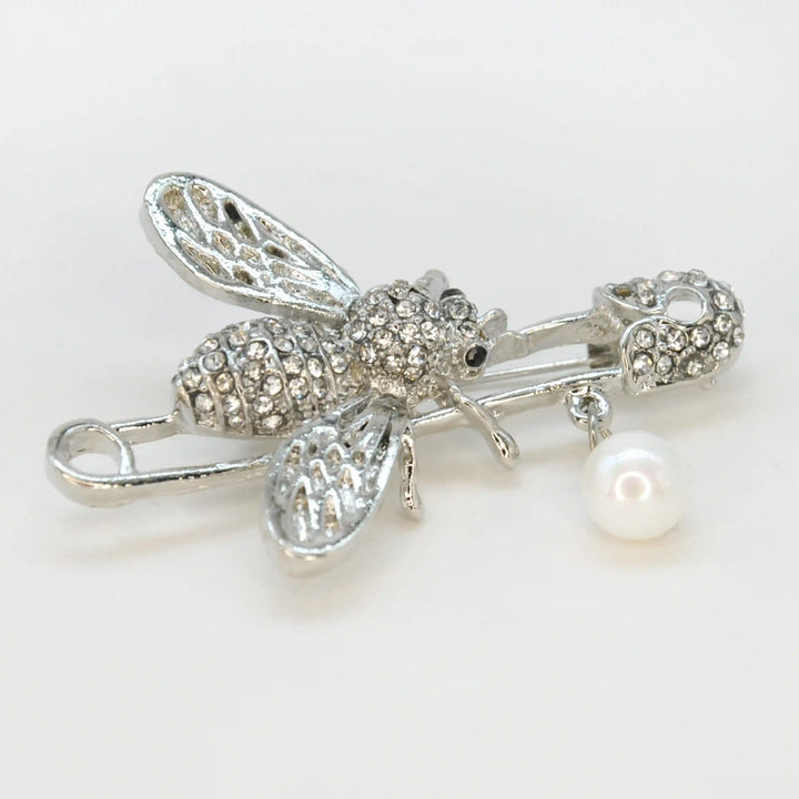Ani Accessories close photo of silver honey bee rhinestone safety pin brooch on white background for fashion accessories.