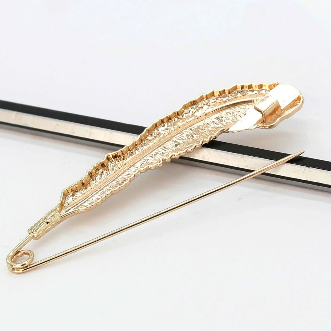 Gold brooch back image with feather intricate design on a white background. Perfect for styling safety pins as coat & blazer brooch and saree brooch 