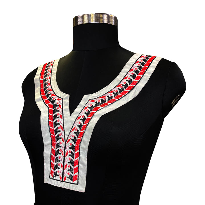 Black and Red Geometric Embroidery on White Fabric Neckline