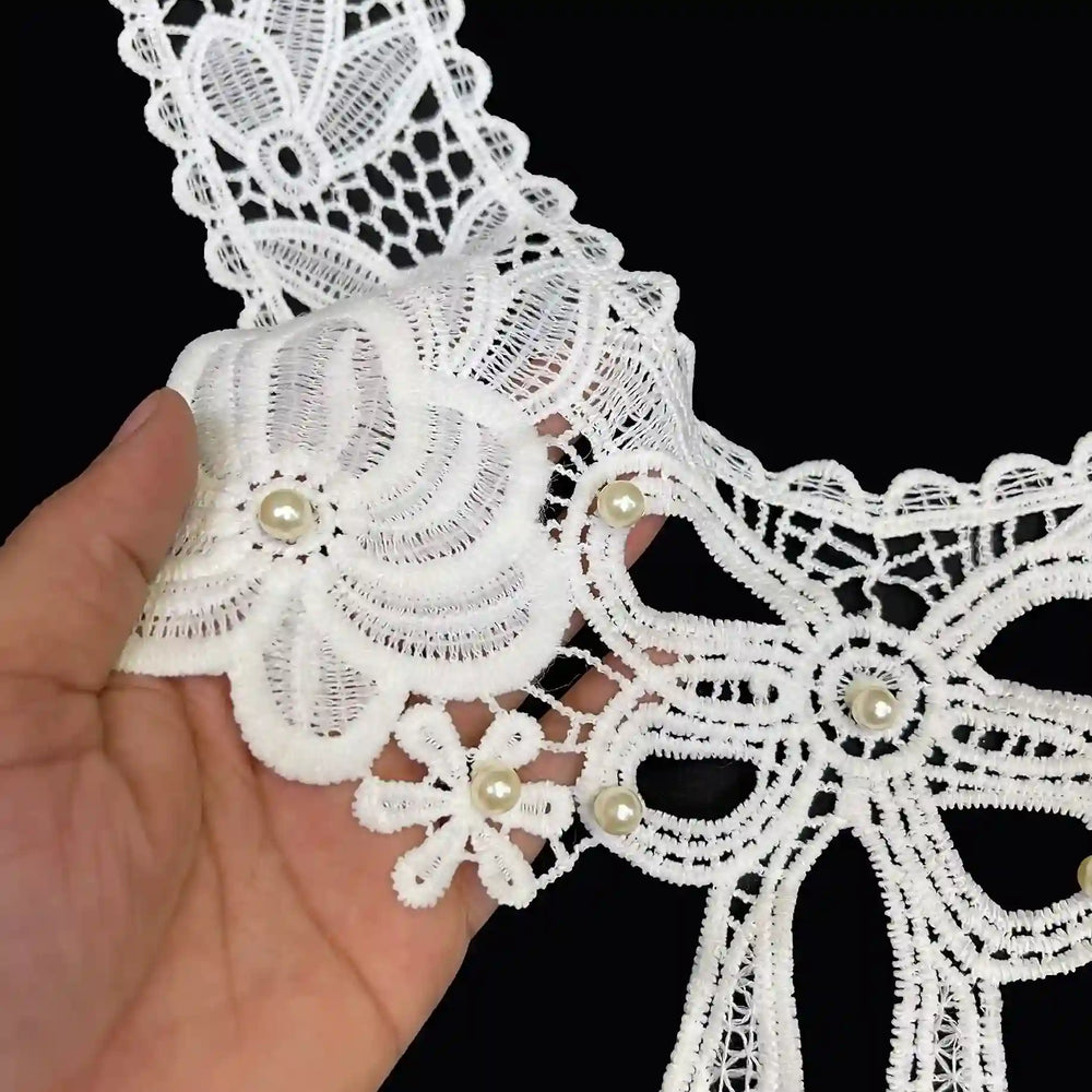 Large bow and flower design neckline close up showing intricate embroidery texture and elegant detailing, dyeable sew-on applique