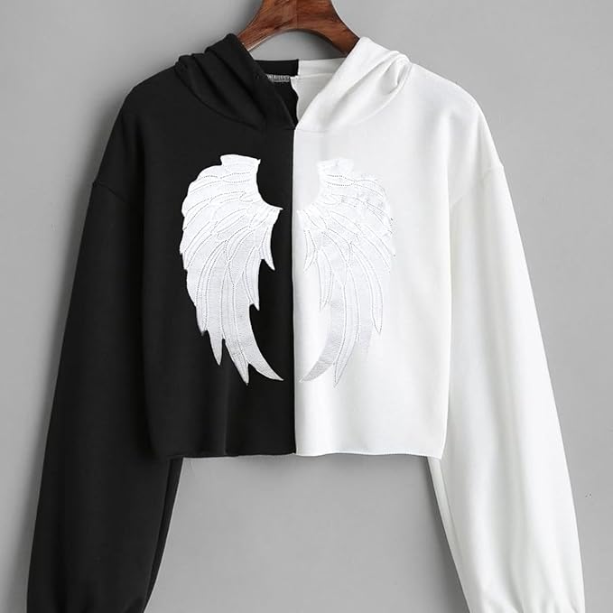 ANI Accessories angel wings patch on the back of a black and white cropped shirt on a hanger 