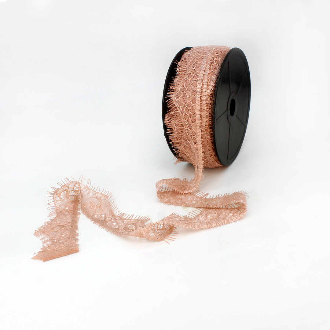 Roll of Peach Eyelash Trim Lace Fabric by Ani Accessories for crafting. Buy now for stylish embellishments.