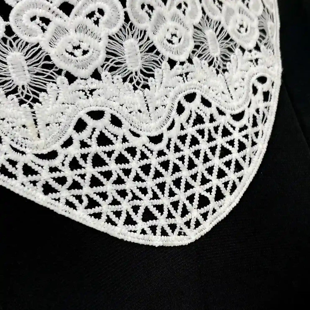 ANI Accessories close-up of the floral neckline patch showing the scalloped flower crown border and triangle lattice base 