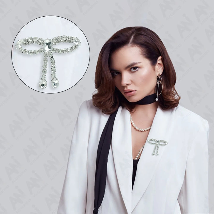 Ani-accessories-crystal-bow-brooch-worn-by-a-woman-on-a-white-blazer.