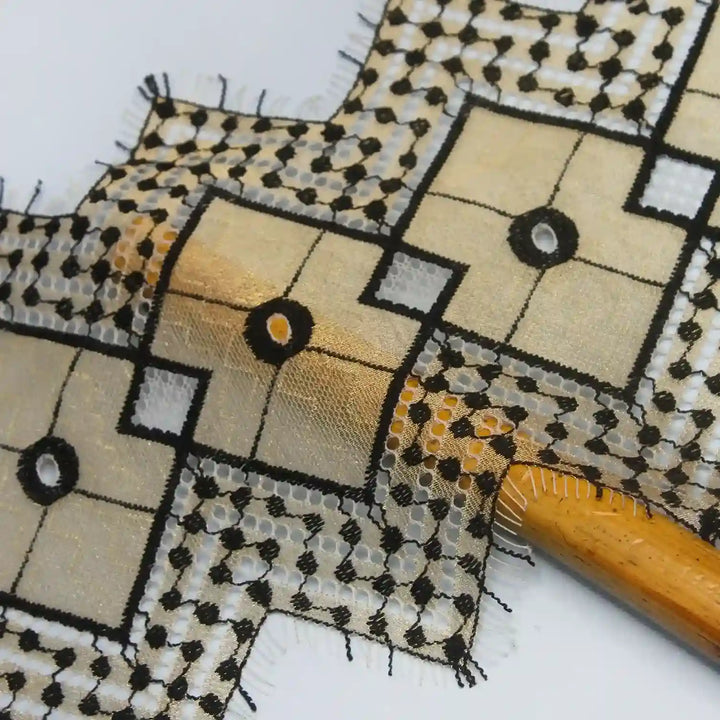 Elegant black and gold patterned fabric by Ani Accessories with intricate designs and sheer texture