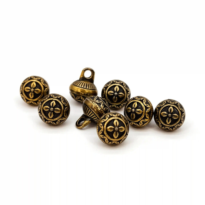 ANI Accessories set of 8 antique gold four-petal flower dome shank buttons scattered on white Background 