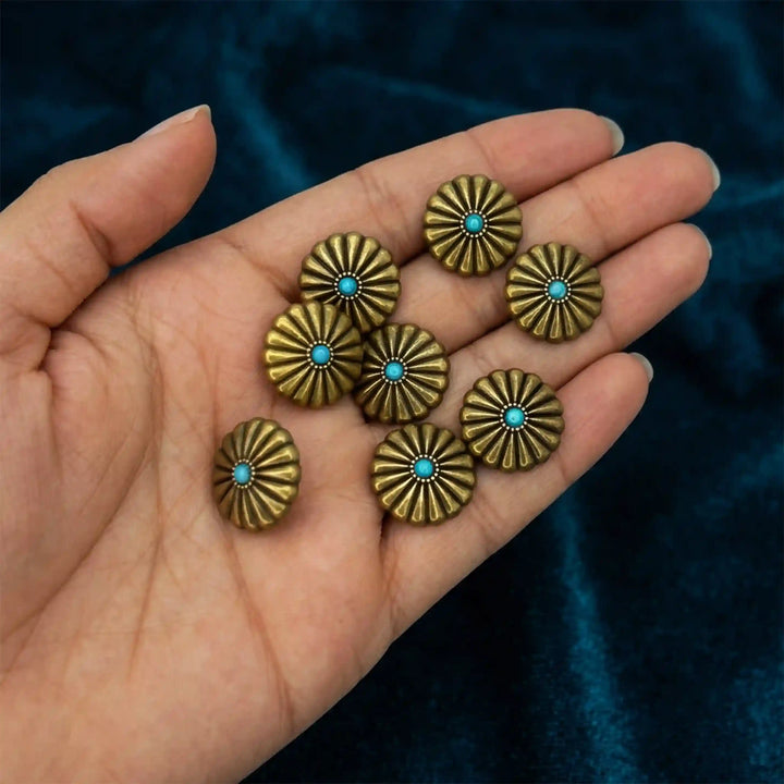 ANI Accessories antique gold sunburst turquoise metal buttons in an open palm to show real size, on teal velvet Color Background 