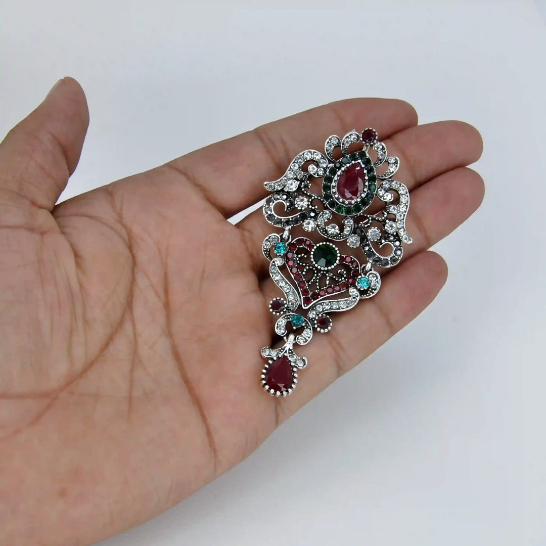 ANI Accessories antique silver brooch held in hand to show its size 