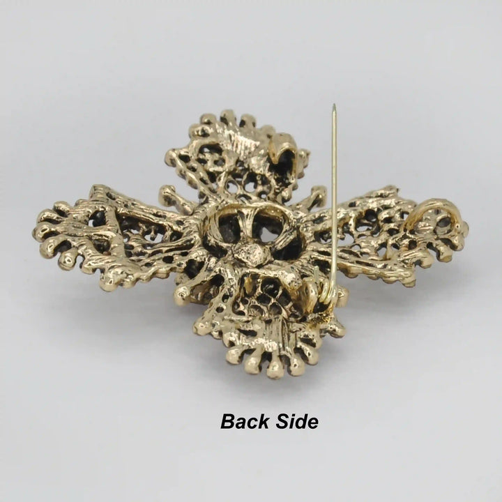 ANI Accessories baroque cross brooch back side showing the antique gold base and pin 