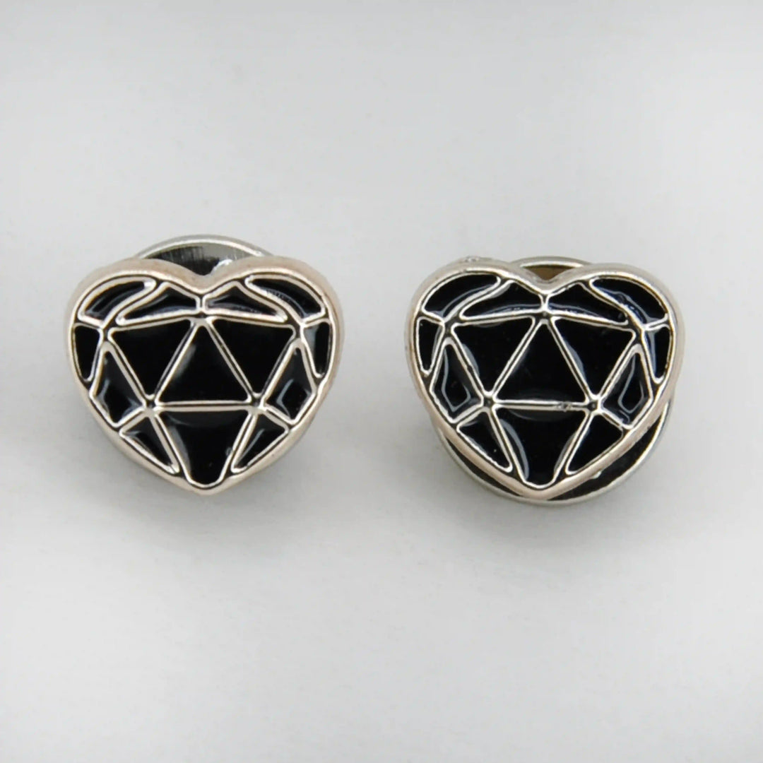 ANI Accessories two black enamel heart pins with geometric silver pattern on grey 