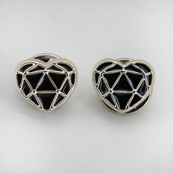 ANI Accessories two black enamel heart pins with geometric silver pattern on grey 