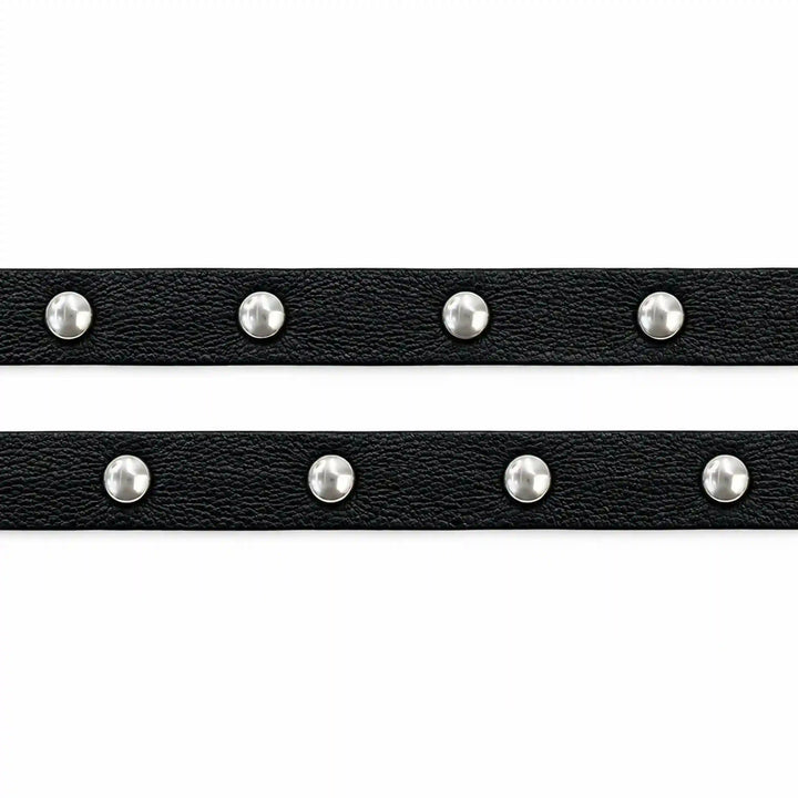 ANI Accessories two black faux leather strips with silver studs laid flat with white color background 