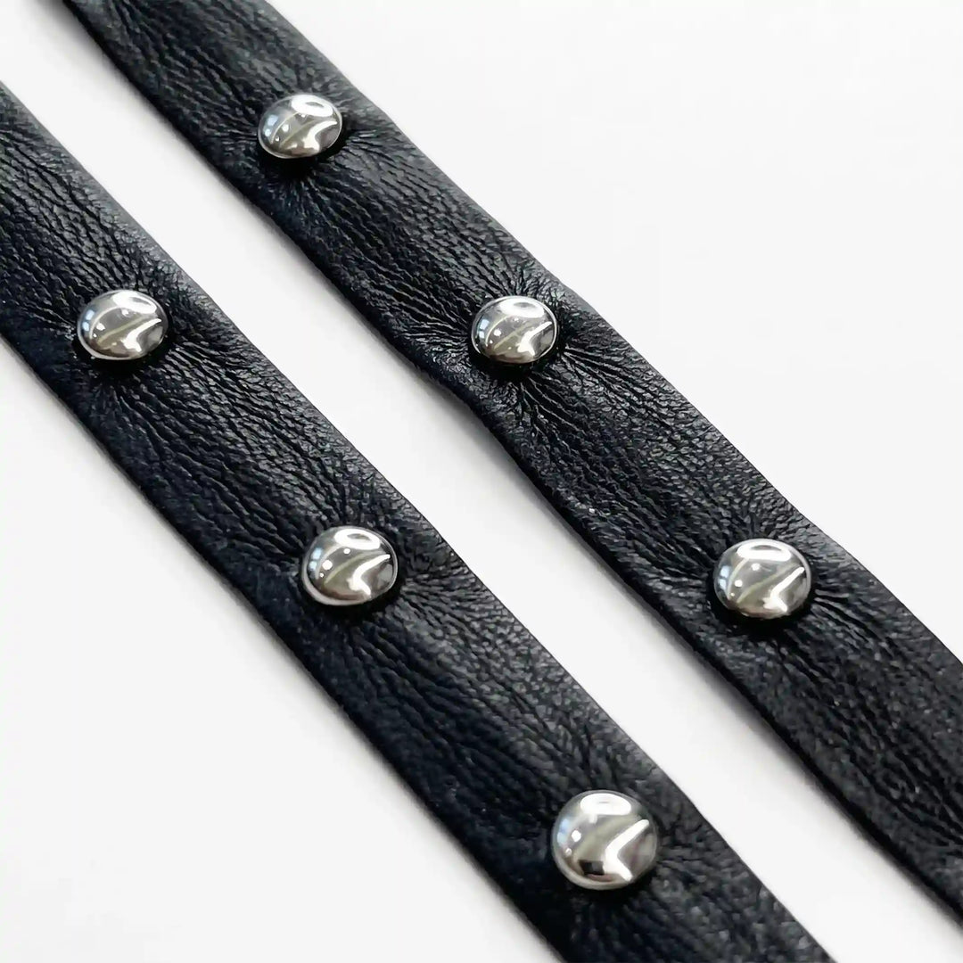 ANI Accessories black studded faux leather metal eyelet lace, 1 cm, in loose loops with white color background 
