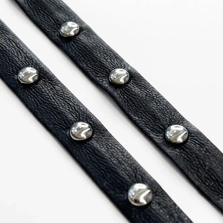 ANI Accessories black studded faux leather metal eyelet lace, 1 cm, in loose loops with white color background 
