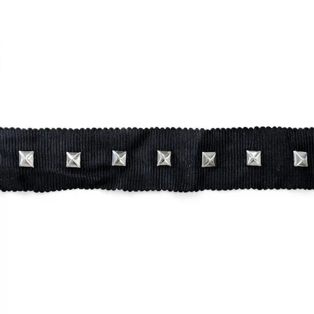 ANI Accessories black studded ribbon trim with pyramid studs laid flat on white color background 