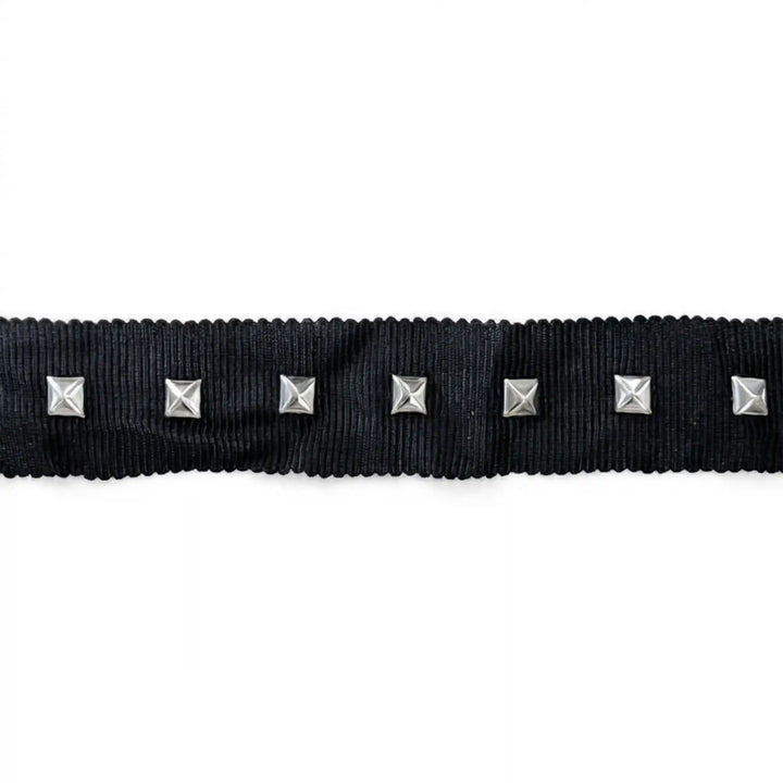 ANI Accessories black studded ribbon trim with pyramid studs laid flat on white color background 
