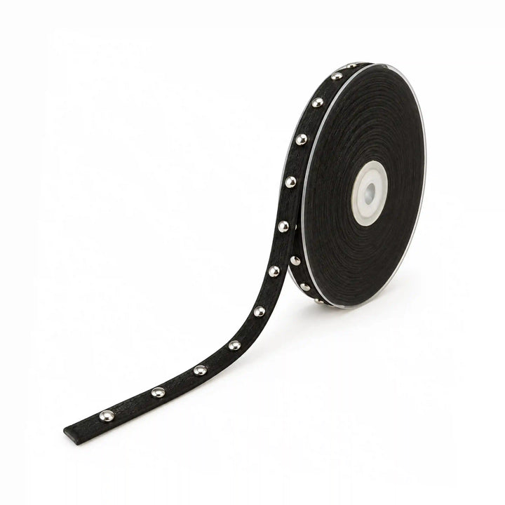 ANI Accessories black studded trim on a spool with silver round studs with white color background 