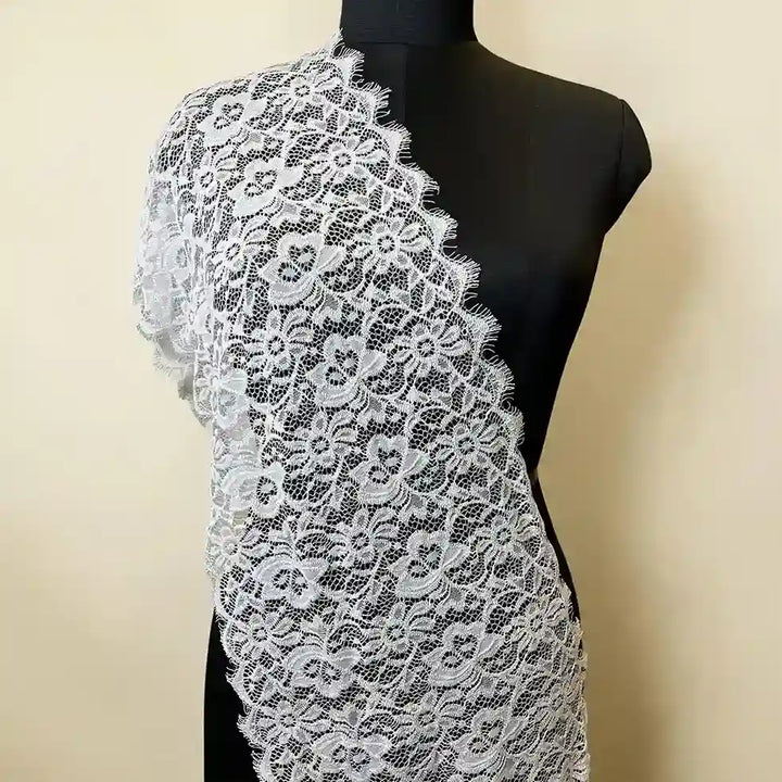 ANI Accessories wide Chantilly lace trim draped on a mannequin as a bridal lace for dupatta with white color background 