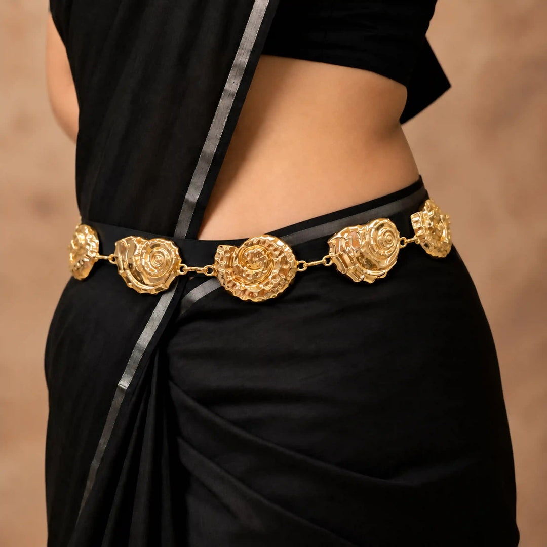 ANI Accessories bright gold seashell chain belt worn on a black saree