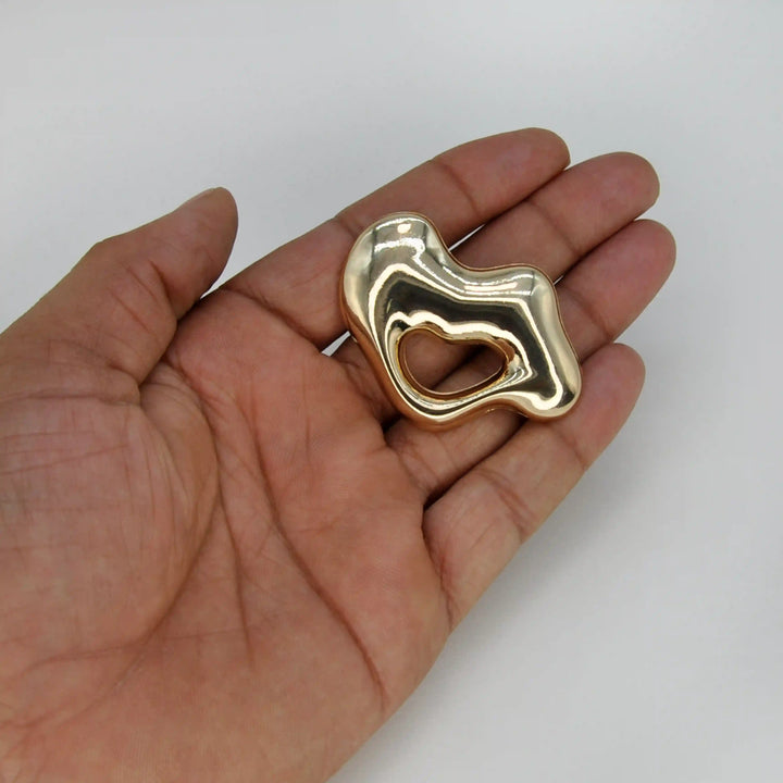 ANI Accessories chunky lips brooch held in hand to show its size 