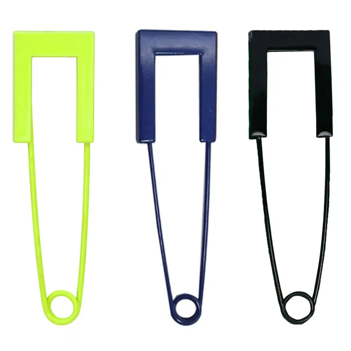 Big colored safety pins in neon, blue and black with flat U-shaped heads