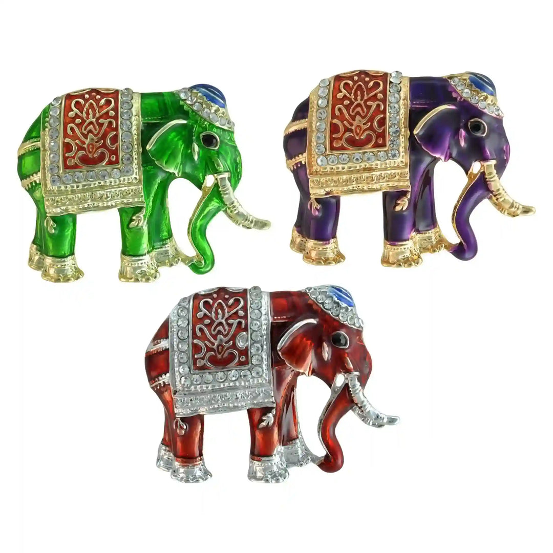 Colourful Indian elephant brooches in red, purple and green on white background 