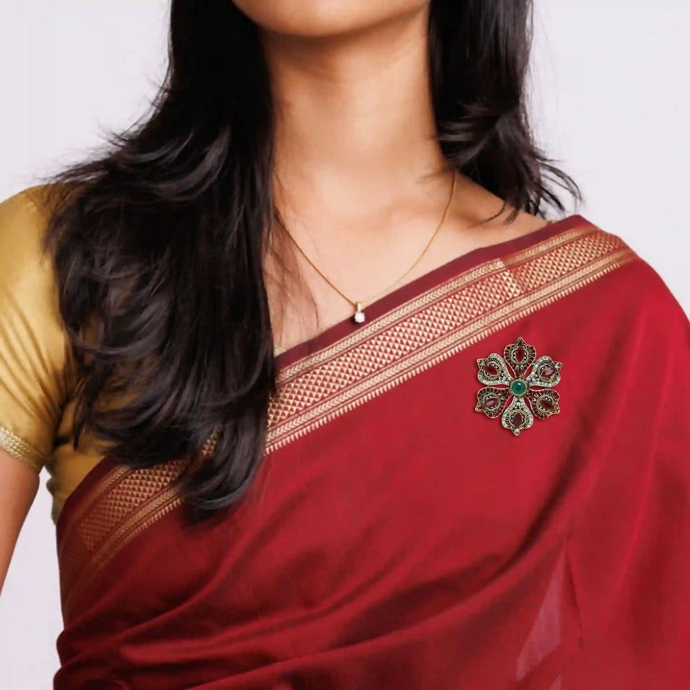 ANI Accessories corsage brooch pinned on the pallu of a red saree 