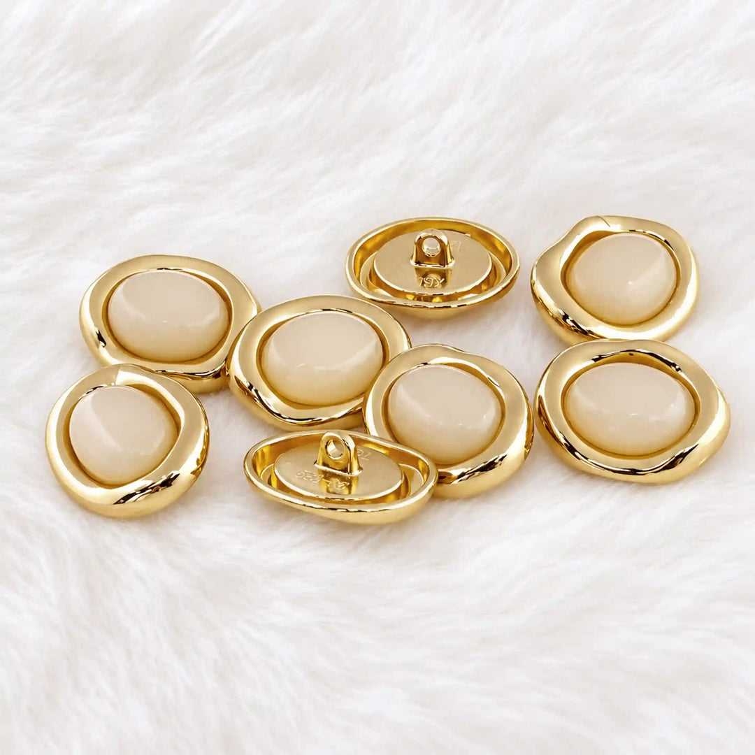 ANI Accessories cream enamel gold buttons on white fur with white color fur background 