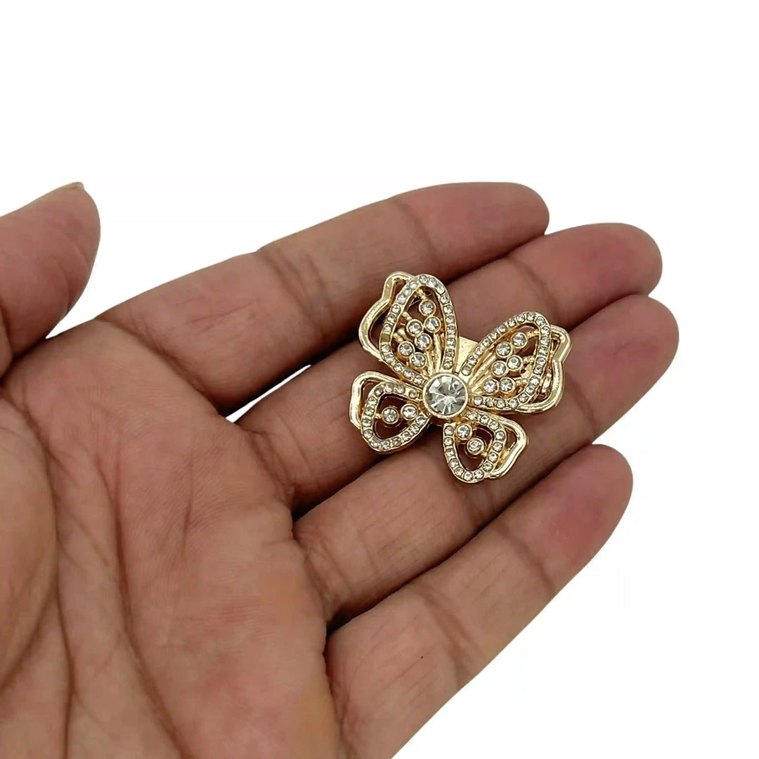 ANI Accessories crystal butterfly brooch held in hand to show its small size color background 