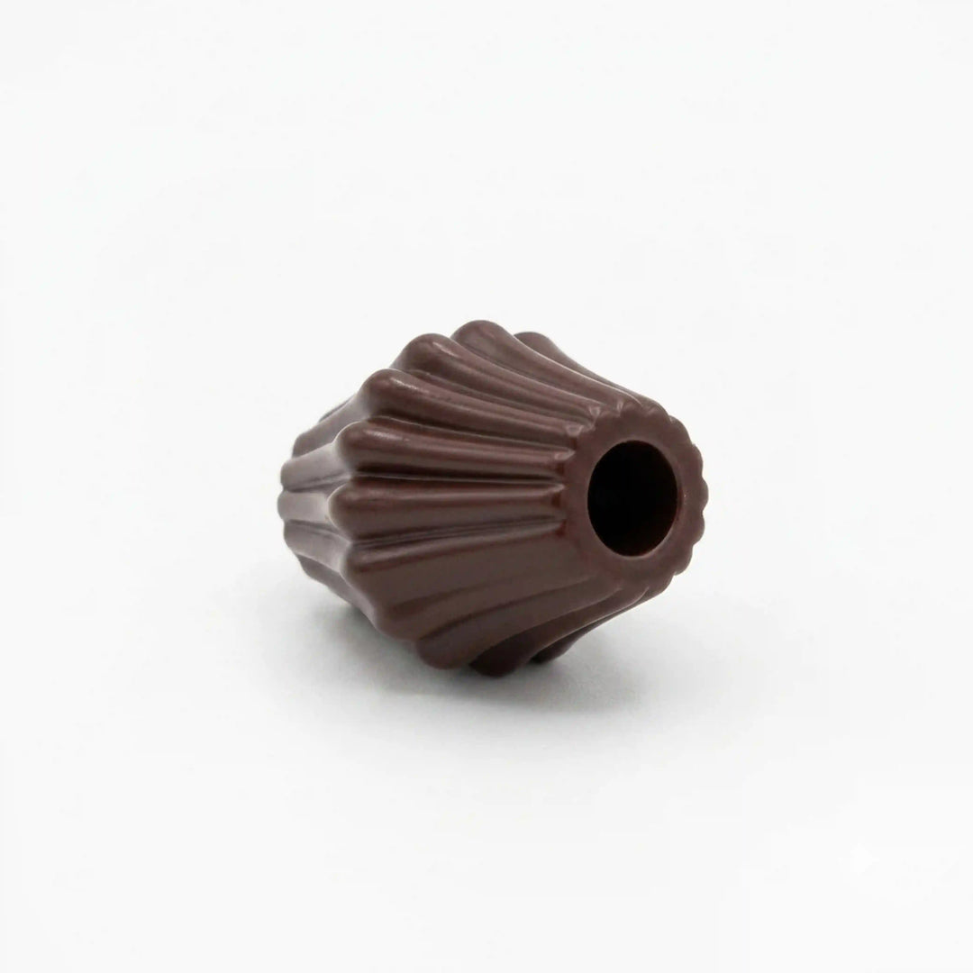 ANI Accessories dark brown melon cord end bead lying on its side, angled view of fluted ridges and hole opening on white Background 