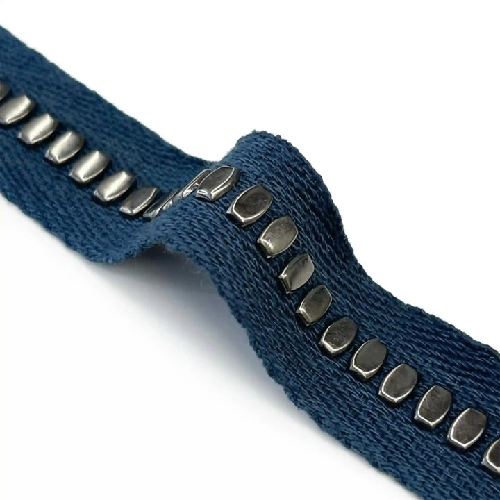 ANI Accessories close-up of oval silver metal studs on denim blue twill tape 