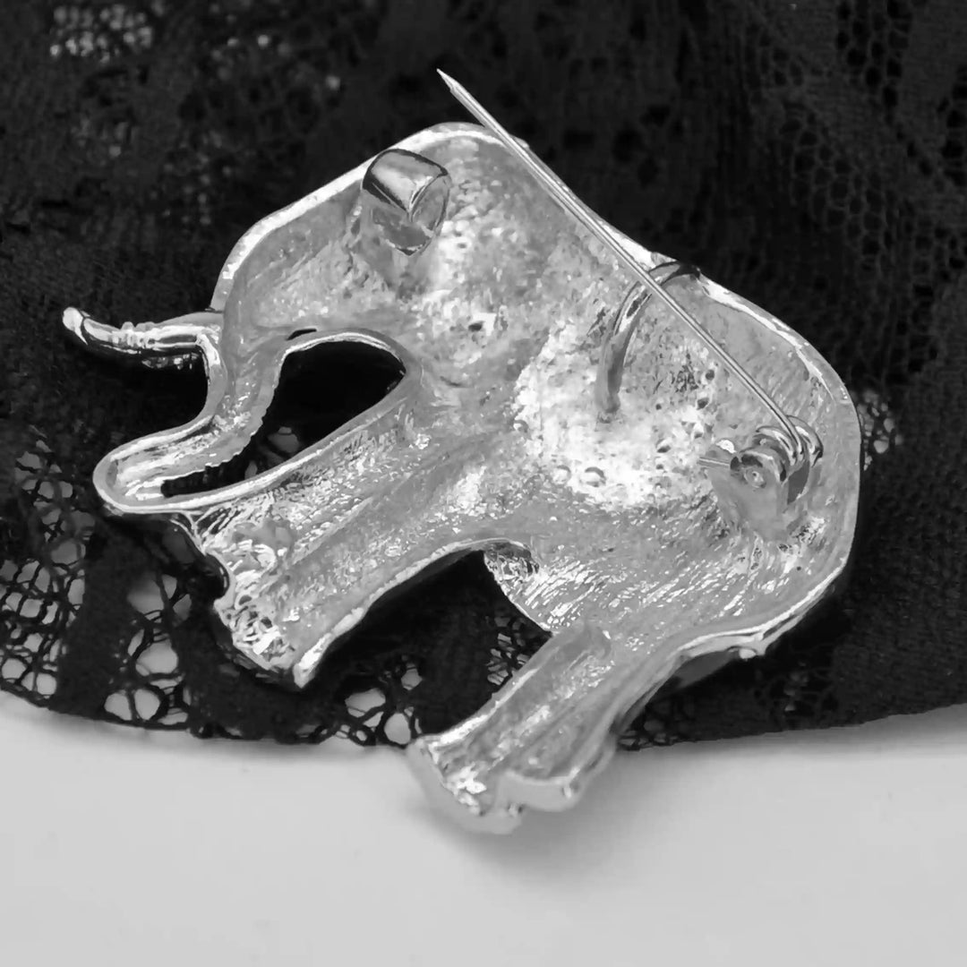Back side of the elephant brooch in silver-tone metal with brooch pin color background 