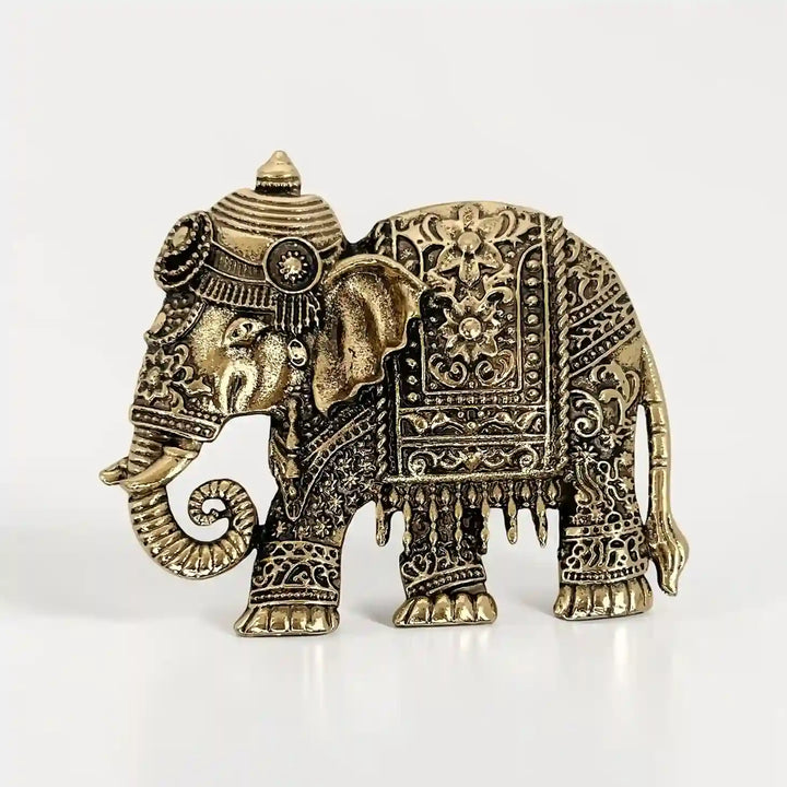 ANI Accessories embossed royal elephant brooch in antique gold with crown headdress and floral saddle cloth with white color background 