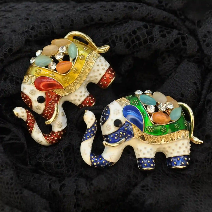 ANI Accessories enamel elephant brooch pins in yellow and green on black lace, close-up 