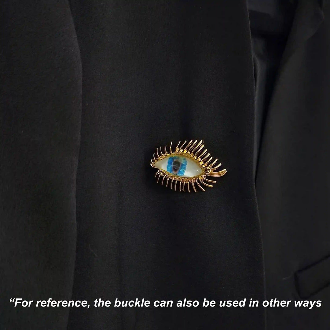 ANI Accessories radiant eye pin brooch pinned on the chest of a black shirt with white color background 