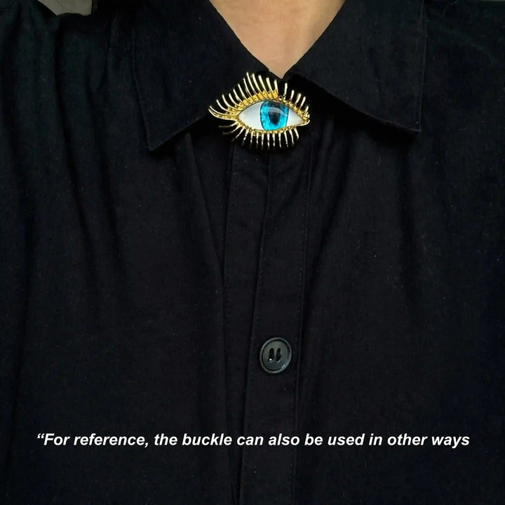 ANI Accessories evil eye pin brooch worn at the collar of a black shirt 