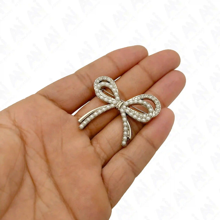 Sparkling Bow Pearl Rhinestone Brooch for Women's Fashion, held in a hand for scale