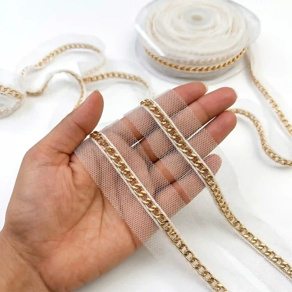 ANI Accessories gold chain trim on net lace held in hand next to the roll 