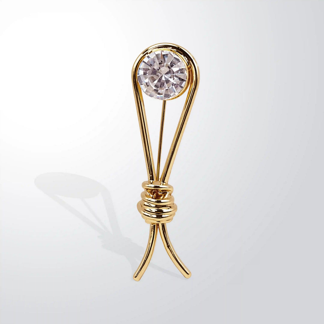 ANI Accessories gold collar brooch with a clear faceted crystal, front angle view with white color background 
