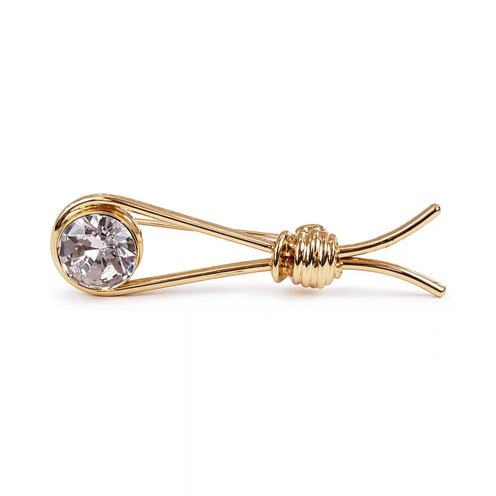 ANI Accessories gold crystal lapel pin lying on its side, showing the wire loop and knot 